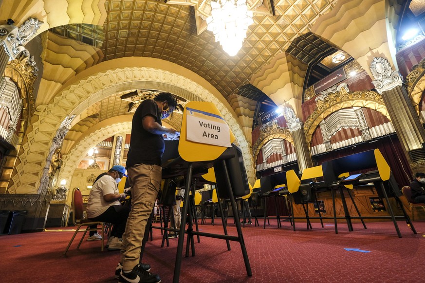 Voters cast their ballots at a vote center in Pantages Theatre during the election day in the Hollywood section of Los Angeles, Tuesday, Nov. 3, 2020. (AP Photo/Ringo H.W. Chiu)