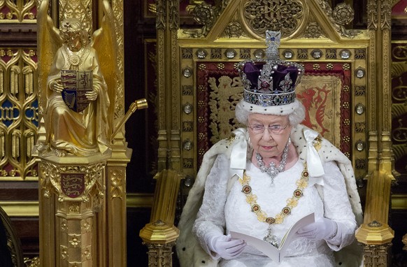Britain&#039;s Queen Elizabeth II wearing the Imperial State Crown as she delivers The Queen&#039;s Speech to Parliament in the House of Lords during the official State Opening of Parliament in London ...