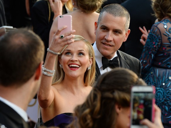Reese Witherspoon, left, and Jim Toth arrive at the Oscars on Sunday, Feb. 28, 2016, at the Dolby Theatre in Los Angeles. (Photo by Al Powers/Invision/AP)