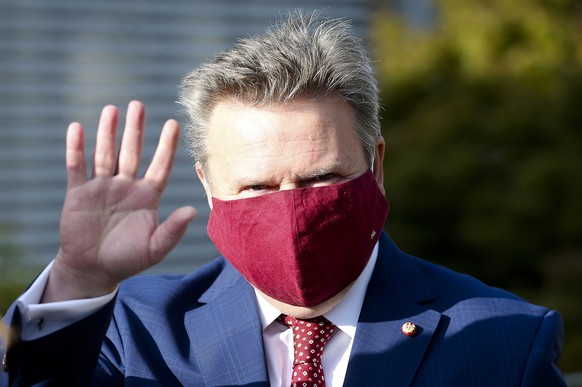 Vienna Mayor Michael Ludwig with face mask from the Social Democrats, SPOE, waves before entering a polling station to the local elections in Vienna, Austria, Sunday, Oct. 11, 2020. (AP Photo/Ronald Z ...