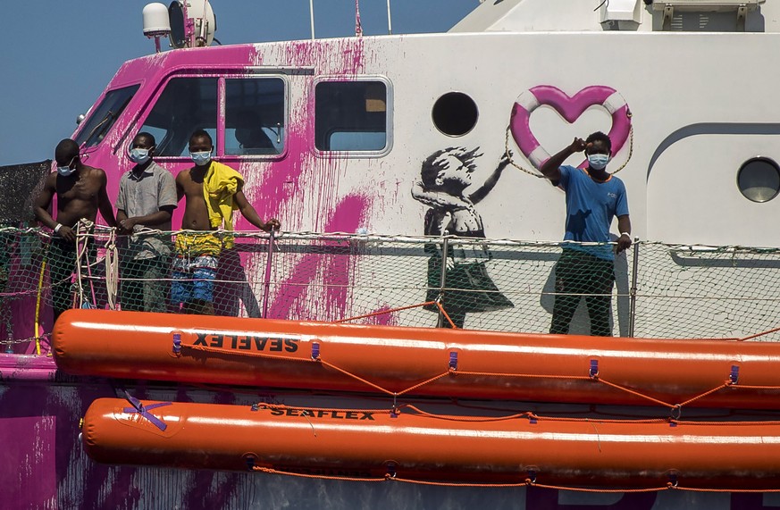 A boy waves to the crew of the Astral rescue vessel from the deck of the Louise Michel� rescue vessel, a French patrol boat currently manned by activists and funded by the renowned artist Banksy in th ...