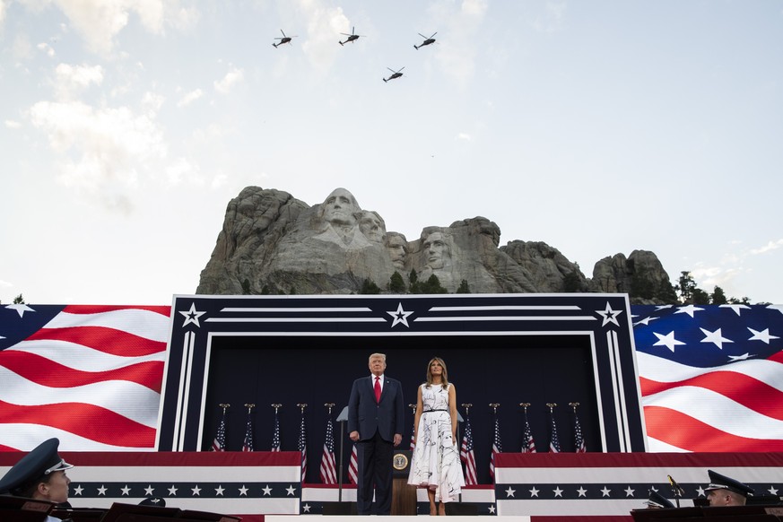 President Donald Trump, accompanied by first lady Melania Trump, stand during a flyover at Mount Rushmore National Memorial, Friday, July 3, 2020, near Keystone, S.D. (AP Photo/Alex Brandon)
Donald Tr ...