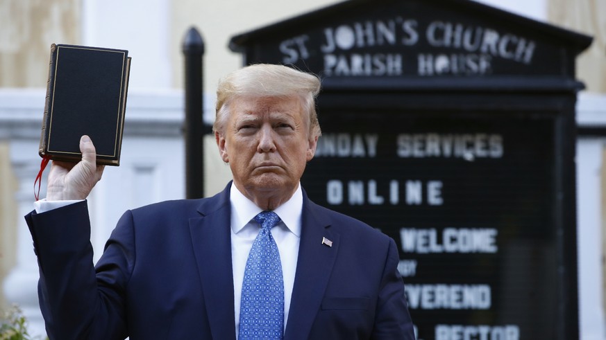 President Donald Trump holds a Bible as he visits outside St. John&#039;s Church across Lafayette Park from the White House Monday, June 1, 2020, in Washington. Part of the church was set on fire duri ...