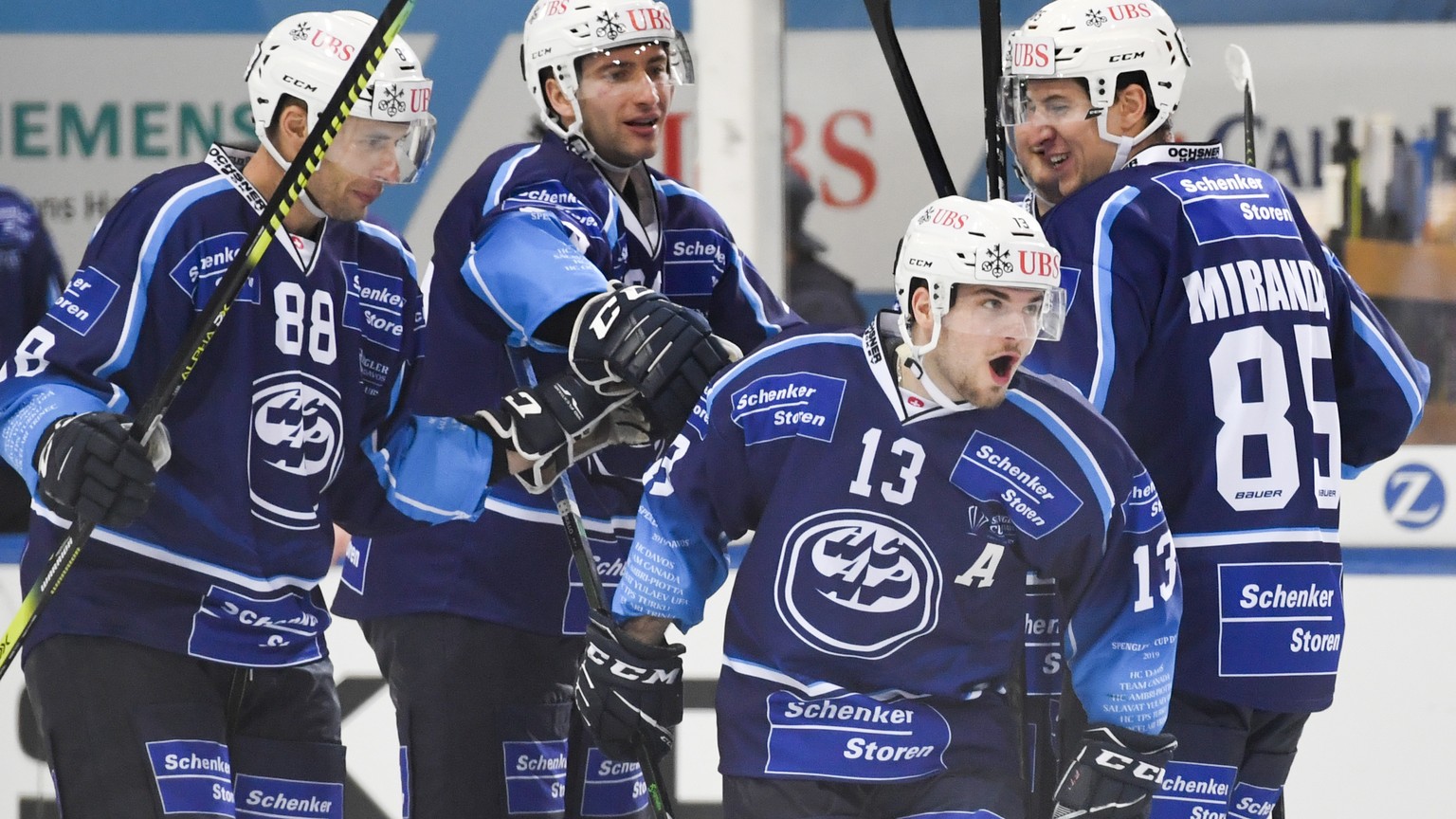 epa08090955 Ambri&#039;s Marco Mueller, second from right, celebrates after scoring 0-3 during the game between HC Ambri-Piotta and Salavat Yulaev Ufa, of the 93rd Spengler Cup ice hockey tournament i ...