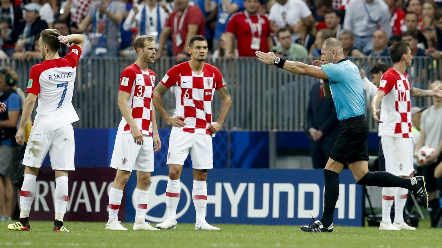 Referee Nestor Pitana from Argentina points to the penalty box after watching the VAR monitor, during the final match between France and Croatia at the 2018 soccer World Cup in the Luzhniki Stadium in ...