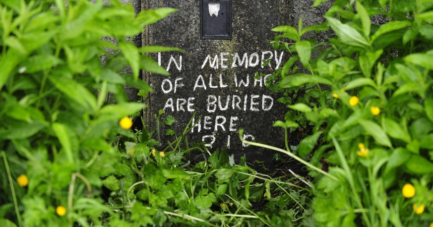 epa08933371 (FILE) - A file photo dated 06 June 2014 showing a handwritten note painted on the site of a mass grave of up to 800 children on the site of the former Mother and Baby home in Tuam, County ...