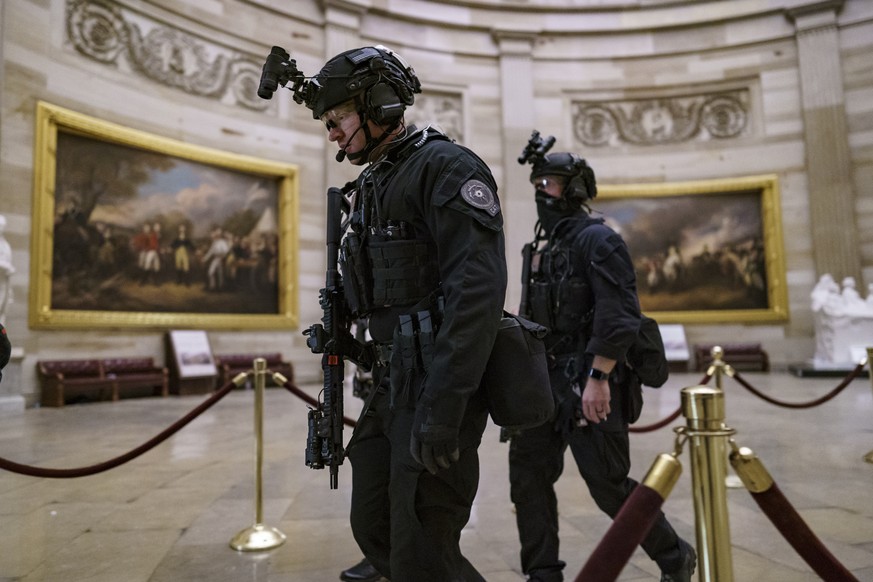 Members of the U.S. Secret Service Counter Assault Team walk through the Rotunda as they and other federal police forces responded as violent protesters loyal to President Donald Trump stormed the U.S ...