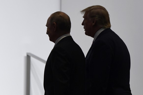 FILE - In this June 28, 2019, file photo, President Donald Trump and Russian President Vladimir Putin walk to participate in a group photo at the G20 summit in Osaka, Japan. The Trump administration i ...