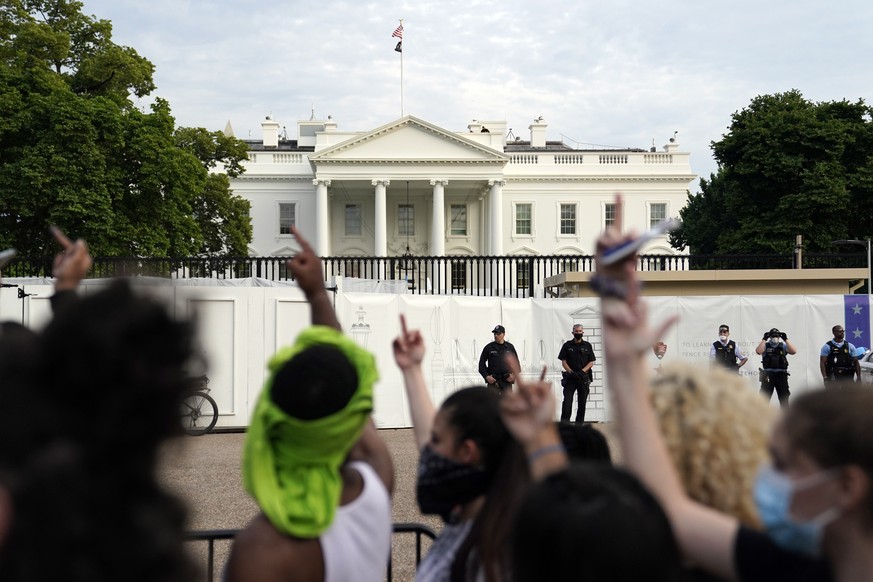 EDS NOTE: OBSCENITY - Demonstrators gather across from the White House to protest the death of George Floyd, a black man who died in police custody in Minneapolis, Friday, May 29, 2020, in Washington. ...