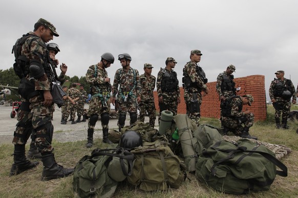 FILE - In this Friday, May 15, 2015, file photo, Nepalese army soldiers prepare to leave for a rescue mission to the site where the suspected wreckage of a U.S. Marine helicopter, that disappeared ear ...
