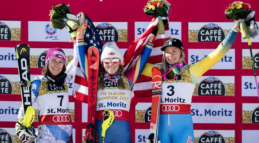 Silver medalist Wendy Holdener, of Switzerland, left, Gold medalist Mikaela Shiffrin, of the U.S.A., center, and Bronze medalist Frida Hansdotter, of Sweden, celebrate on the podium, during the flower ...