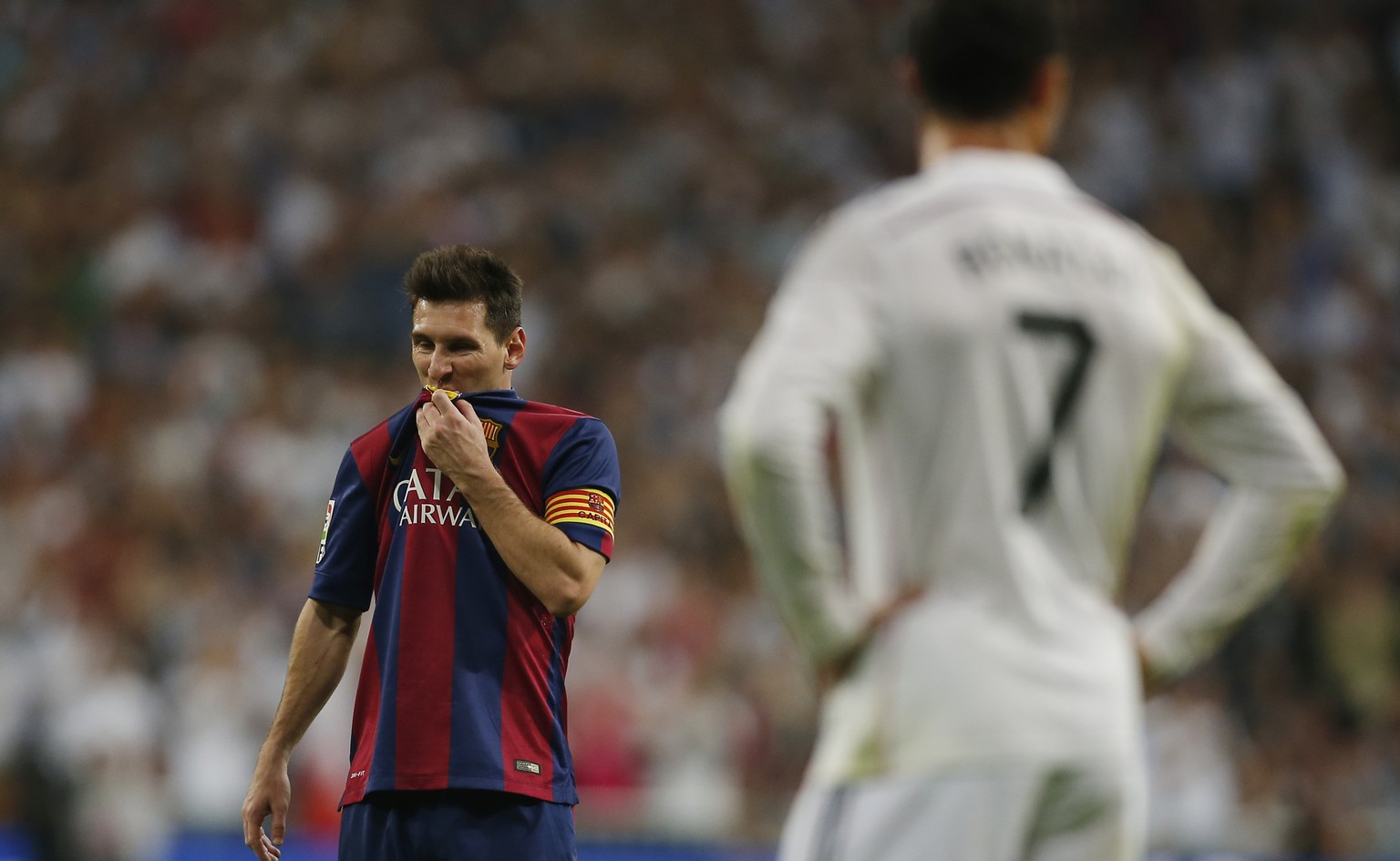Barcelona&#039;s Lionel Messi, left, gestures next to Real Madrid&#039;s Cristiano Ronaldo, right, during a Spanish La Liga soccer match between Real Madrid and FC Barcelona at the Santiago Bernabeu s ...