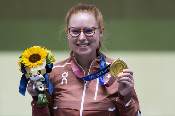Gold medal winner Nina Christen of Switzerland celebrates on the podium after the women&#039;s shooting 50m Rifle 3 Positions Finals at the 2020 Tokyo Summer Olympics in Tokyo, Japan, on Saturday, Jul ...