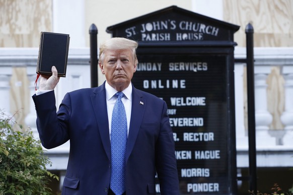 FILE - In this June 1, 2020, file photo President Donald Trump holds a Bible as he visits outside St. John&#039;s Church across Lafayette Park from the White House in Washington. (AP Photo/Patrick Sem ...