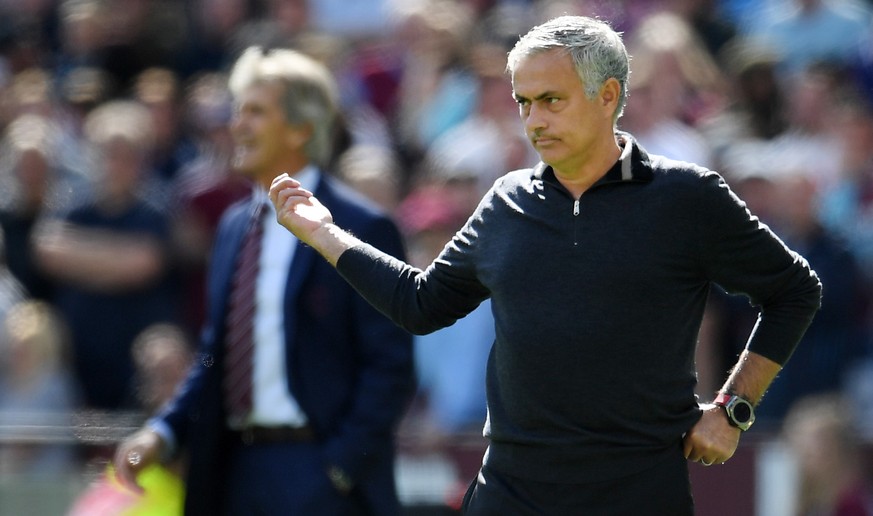 epa07056154 Manchester United manager Jose Mourinho (R) reacts during the English Premier League soccer match between West Ham and Manchester United at the London Stadium in Stratford, east London, Br ...