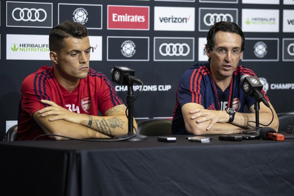 epa07721355 Arsenal FC coach Unai Emery (R) and Granit Xhaka (L) of Arsenal FC attend a press conference held the day before their match against FC Bayern Munich at Dignity Health Sports Park in Carso ...