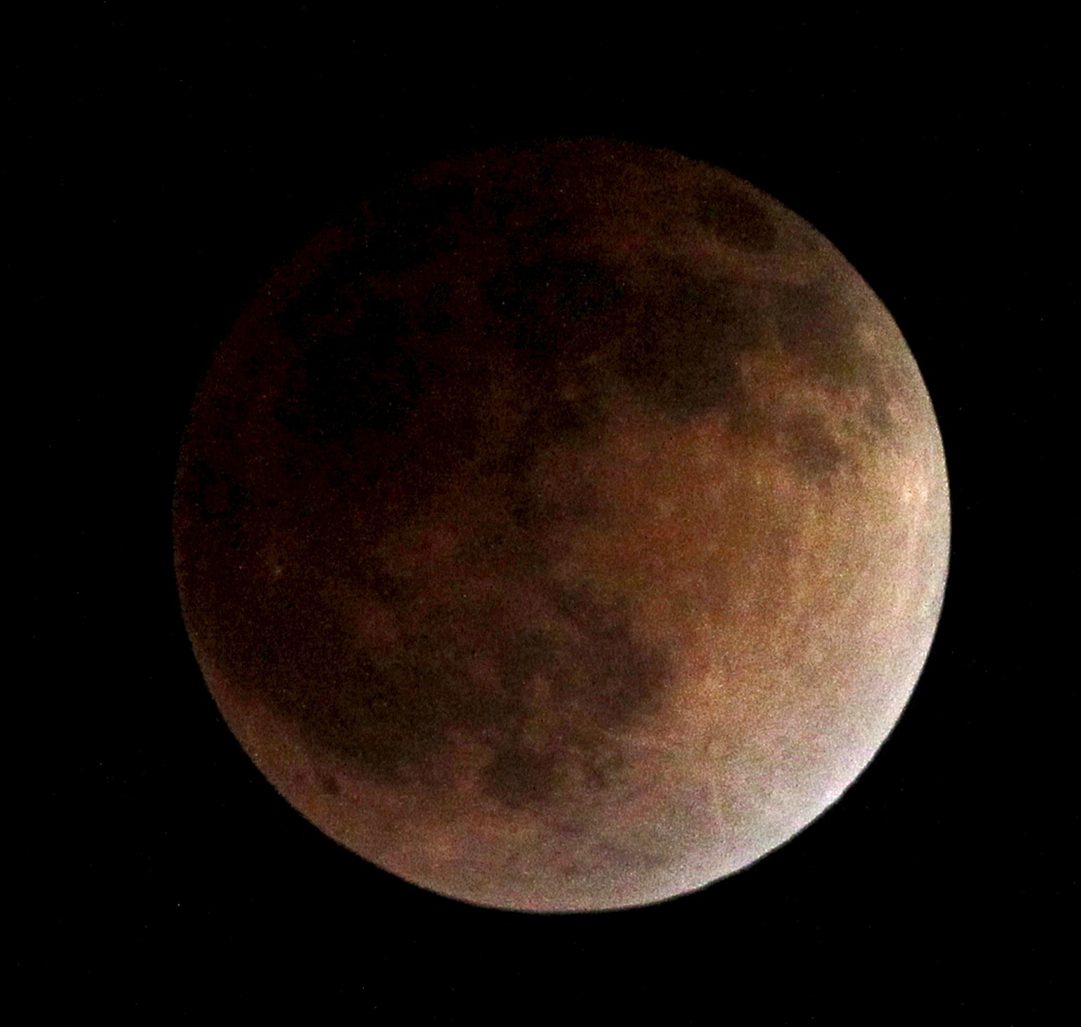 As the moon completely crosses the earth&#039;s shadow, the first of four total lunar eclipses, called the Blood Moon, occur in Whittier, Ca., USA on Tuesday, April 15, 2014. (AP Photo/Nick Ut )