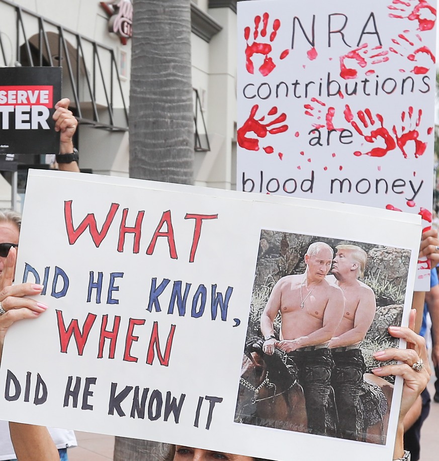 epa06895340 Demonstrators rally against Russian influence on US president Donald Trump, local Republican Representative Dana Rohrabacher and the National Rifle Association (NRA) during a protest in Hu ...