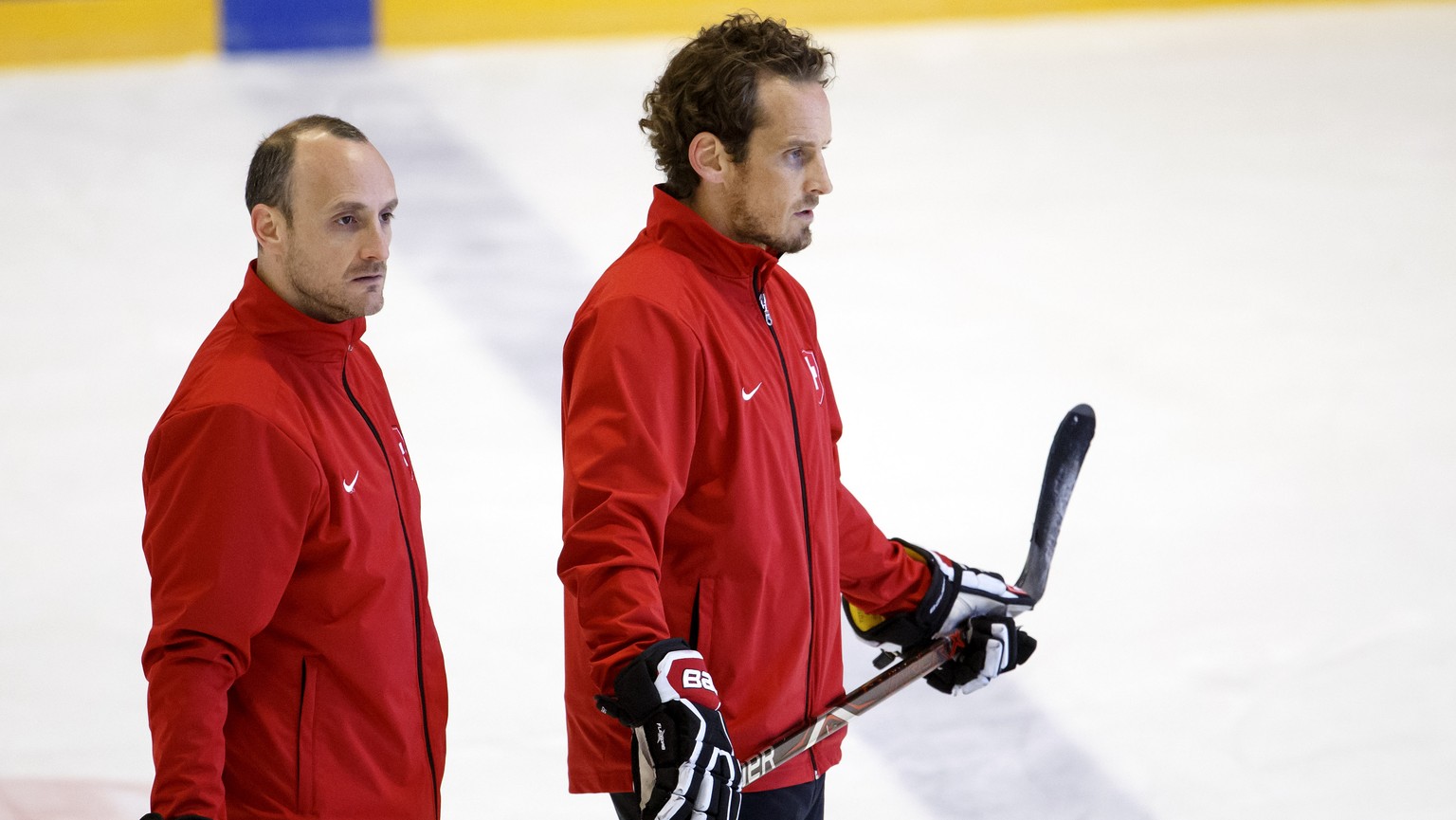 Christian Wohlwend, left, assistant coach of Switzerland national ice hockey team, and Patrick Fischer, right, head coach of Switzerland national ice hockey team, look their players, during a training ...