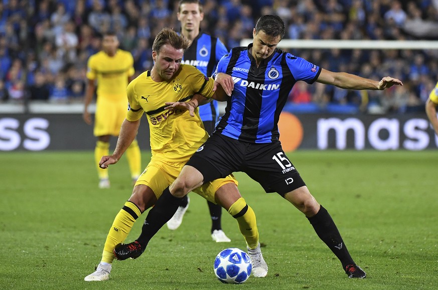 Dortmund&#039;s Mario Goetze, left, and Brugge defender Matej Mitrovic challenge for the ball during the Champions League group A soccer match between Club Brugge and Borussia Dortmund at the Jan Brey ...