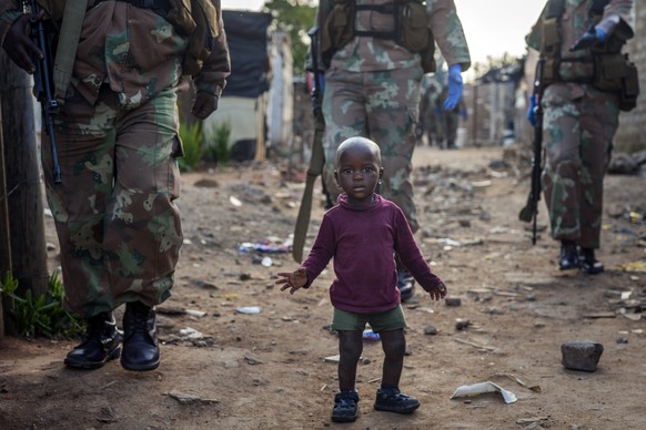 South African National Defense Forces patrol the Sjwetla informal settlement after pushing back residents into their homes, on the outskirts of the Alexandra township in Johannesburg, Monday, April 20 ...