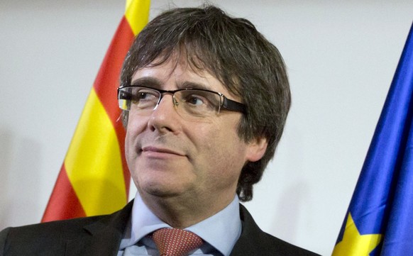 FILE - In this Dec. 21, 2017 file photo ousted Catalan leader Carles Puigdemont takes the podium at a gathering to watch the election results for Spain&#039;s Catalonia region at the Square Meeting Ce ...