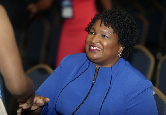 FILE- In this Aug. 3, 2018, file photo, Georgia gubernatorial candidate Stacey Abrams is greeted before speaking at the National Association of Black Journalists in Detroit. Abrams is aiming to become ...