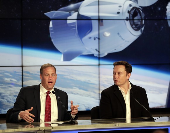 NASA Administrator Jim Bridenstine, left, and Elon Musk, CEO of SpaceX, answer questions during a news conference after the SpaceX Falcon 9 Demo-1 launch at the Kennedy Space Center in Cape Canaveral, ...