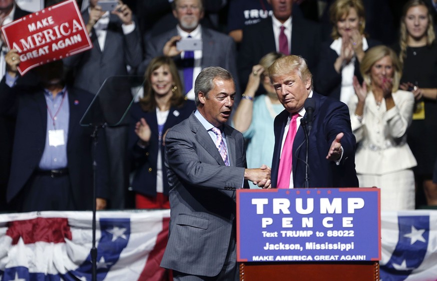 Republican presidential candidate Donald Trump welcomes Nigel Farage, ex-leader of the British UKIP party, to speak at a campaign rally in Jackson, Miss., Wednesday, Aug. 24, 2016. (AP Photo/Gerald He ...