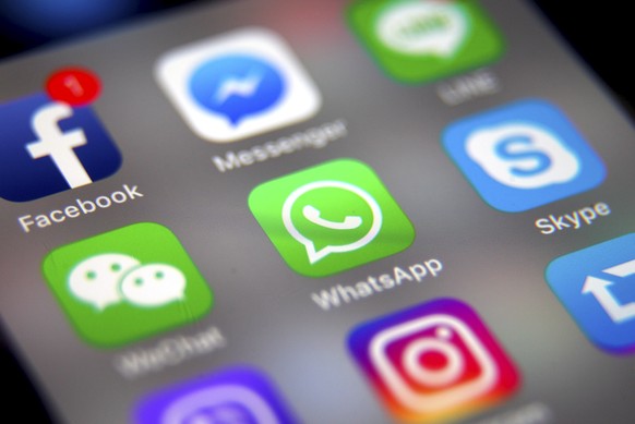 epa07306573 (FILE) - The logo of the messaging application WhatsApp (C) is pictured on a smartphone screen in Taipei, Taiwan, 26 September 2017 (reissued 21 January 2019). Facebook&#039;s messenger se ...