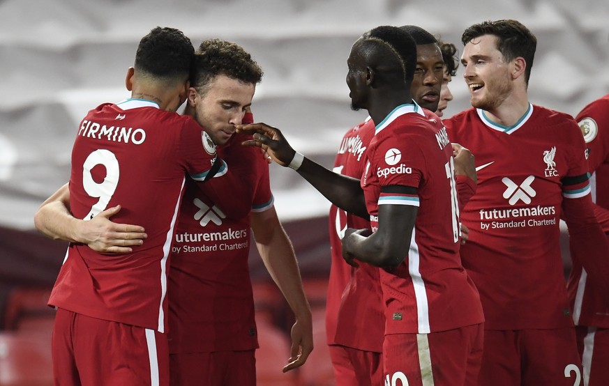 epa08836635 Roberto Firmino (L) of Liverpool celebrates after scoring the 3-0 with team mates during the English Premier League soccer match between Liverpool FC and Leicester City in Liverpool, Brita ...