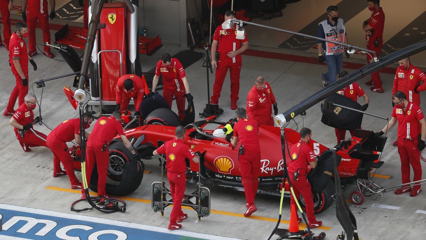 Mechanics work on the car of Ferrari driver Sebastian Vettel of Germany during the second practice session for the upcoming Russian Formula One Grand Prix, at the Sochi Autodrom circuit, in Sochi, Rus ...
