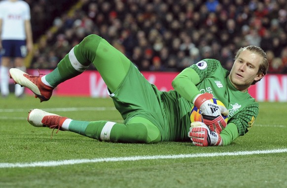 FILE - In this Feb. 4, 2018, file photo, Liverpool&#039;s Loris Karius lies on the field during an English Premier League soccer match against Tottenham Hotspur in Liverpool, England. Doctors based in ...