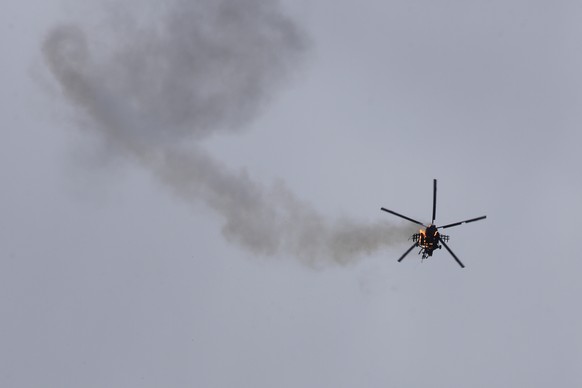 FILE - In this Feb. 11, 2020, file photo, Syrian government helicopter is shot by a missile in Idlib province, Syria. SyriaÄôs civil war has long provided a free-for-all battlefield for proxy fighter ...
