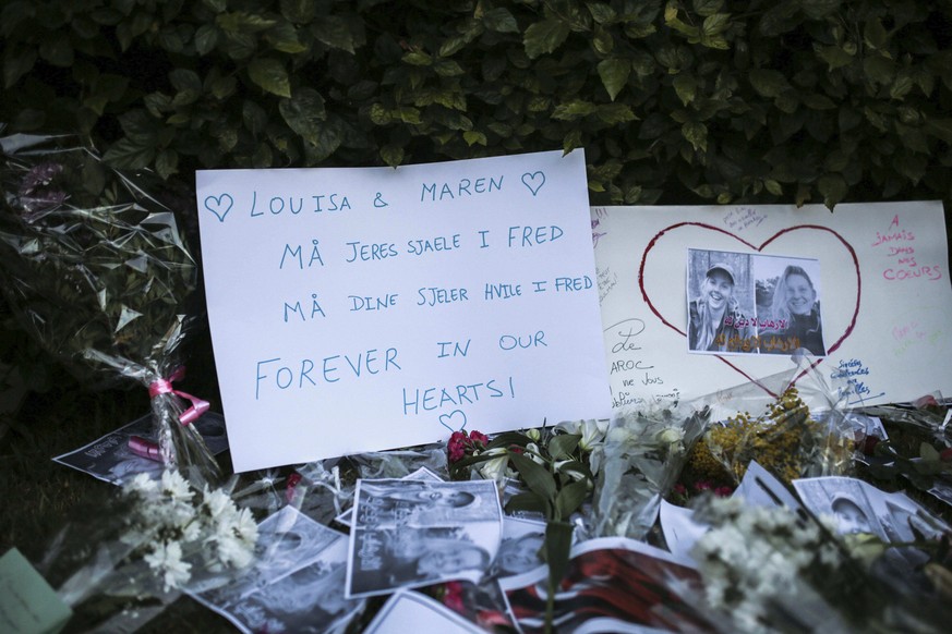Flowers, candles and messages are laid during a vigil outside the Norwegian embassy in Rabat for two Scandinavian university students who were killed in a terrorist attack in a remote area of the Atla ...