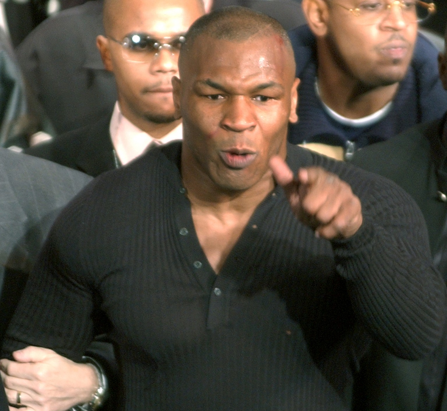 Boxer Mike Tyson threatens members of the media after a brawl broke out on stage during a press conference announcing an upcoming April 6 fight between heavyweight champion Lennox Lewis and Tyson in t ...