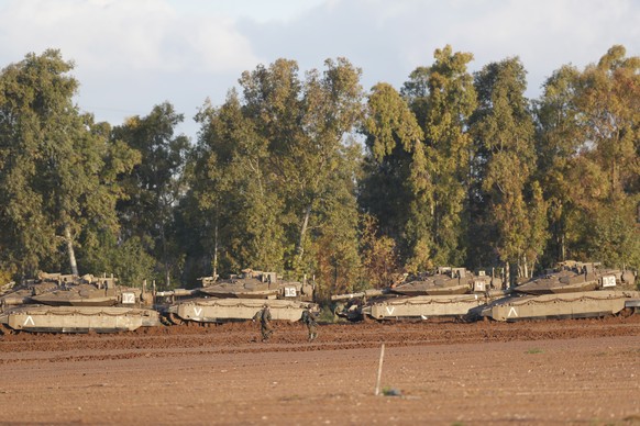 epa07463892 Israeli Merkava tanks and APCs sit at a gathering point next to the border with Gaza, 26 March 2019. Israeli army is targeting Hamas militant installations in the Gaza Strip in response to ...