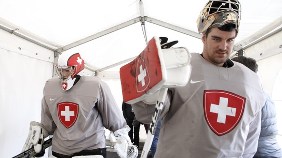 Switzerland&#039;s goaltender Leonardo Genoni, left, and Switzerland&#039;s goaltender Reto Berra, return to cloakroom, after a training session of the IIHF 2018 World Championship at the practice are ...