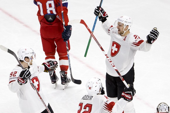 Switzerland&#039;s forward Nino Niederreiter, right, celebrates his goal with teammates forward Gaetan Haas, left, and forward Simon Moser, center, after scoring the 2:4, during the IIHF 2018 World Ch ...