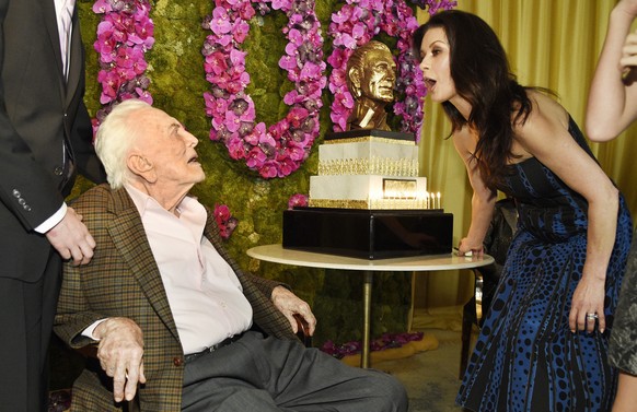 Actor Kirk Douglas, left, mingles with his daughter-in-law, actress Catherine Zeta-Jones, during his 100th birthday party at the Beverly Hills Hotel on Friday, Dec. 9. 2016, in Beverly Hills, Calif. ( ...