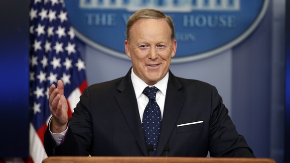 FILE - In this Tuesday, June 20, 2017, file photo, then-White House press secretary Sean Spicer smiles as he answers a question during a briefing at the White House, in Washington. A black man has acc ...