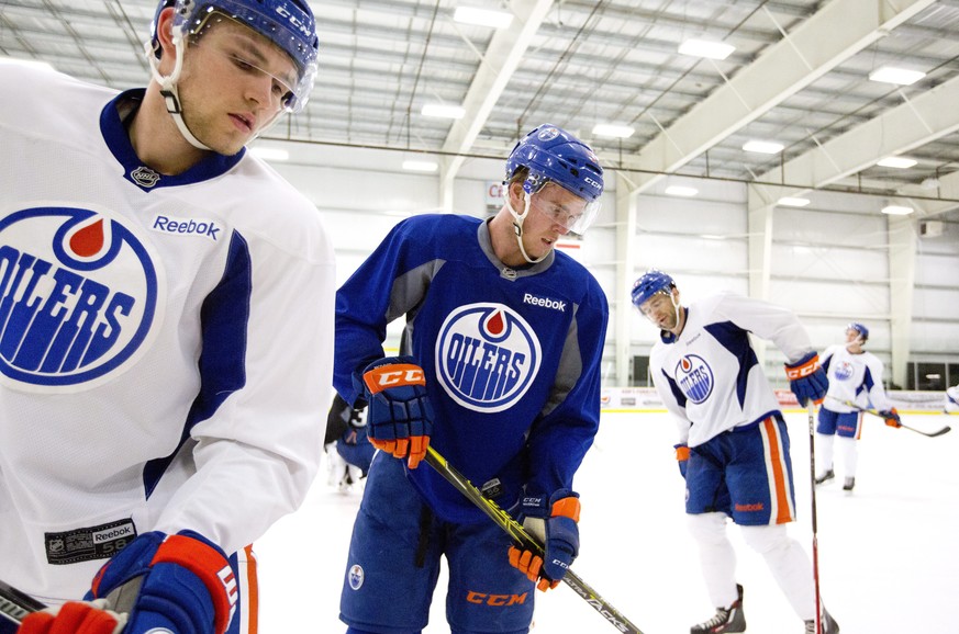 Edmonton Oilers; Leon Draisaitl, left, Connor McDavid, centre, and Matt Ford take part in NHL hockey training camp in Leduc, Alberta, Friday, Sept. 18, 2015. (Jason Franson/The Canadian Press via AP)  ...