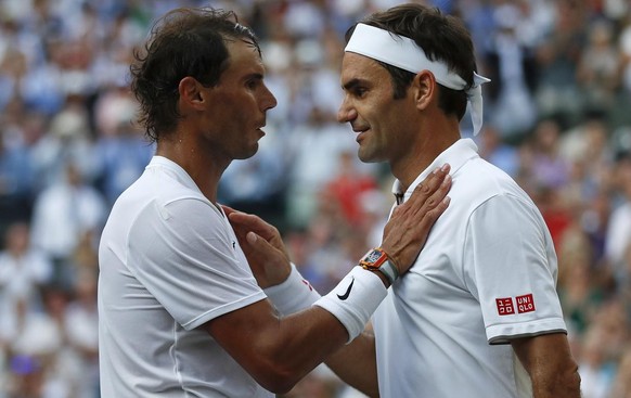 Switzerland&#039;s Roger Federer, right, greets Spain&#039;s Rafael Nadal after beating him in a Men&#039;s singles semifinal match on day eleven of the Wimbledon Tennis Championships in London, Frida ...