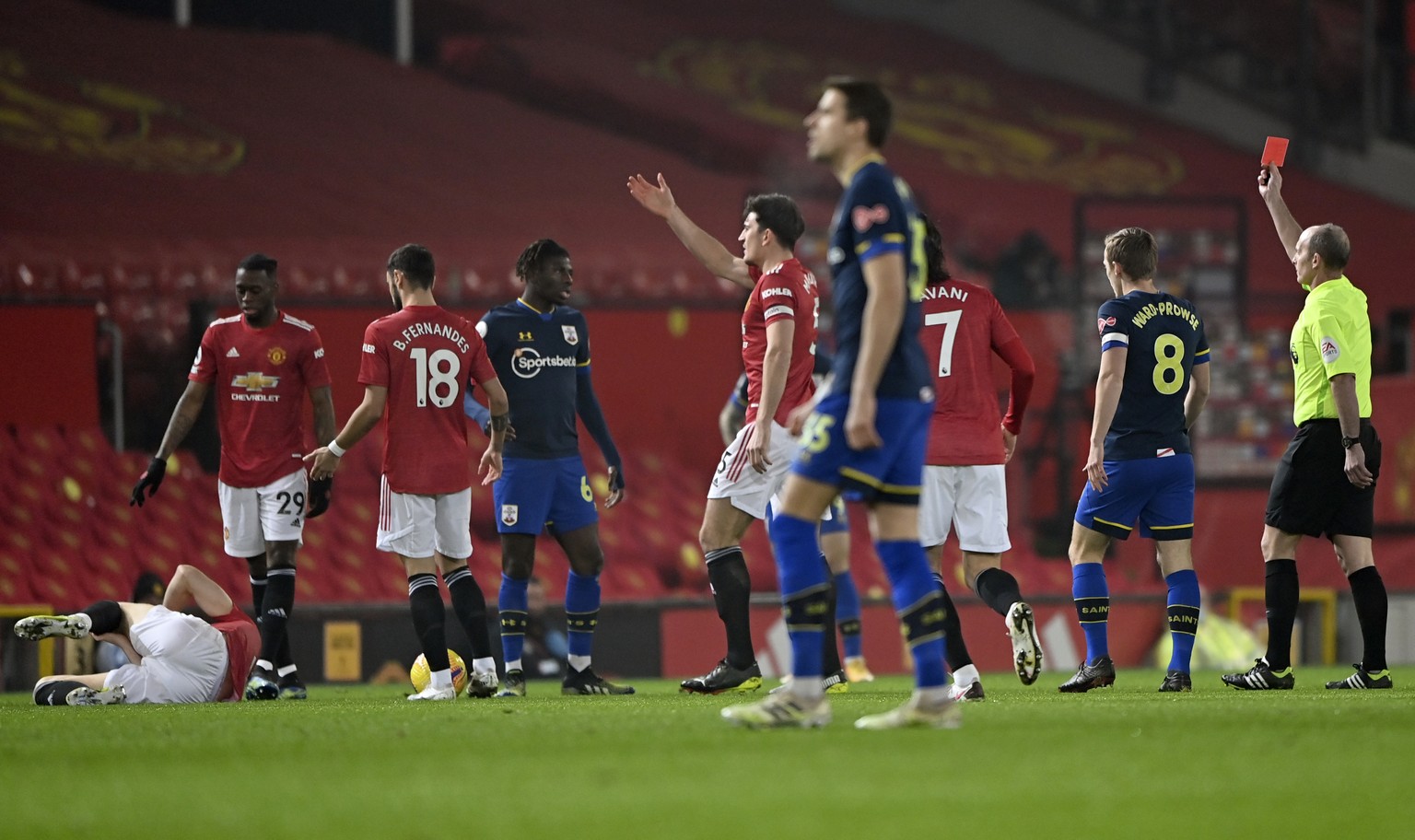 Referee Mike Dean, right, shows a red card to Southampton&#039;s Alex Jankewitz, fourth left, during the English Premier League soccer match between Manchester United and Southampton, at the Old Traff ...
