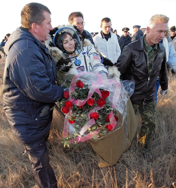 Russian search and recover specialists carry U.S. entrepreneur and the world&#039;s first female space tourist Anousheh Ansari shortly after landing of Russian Souyz space capsule not far from Kazakh  ...