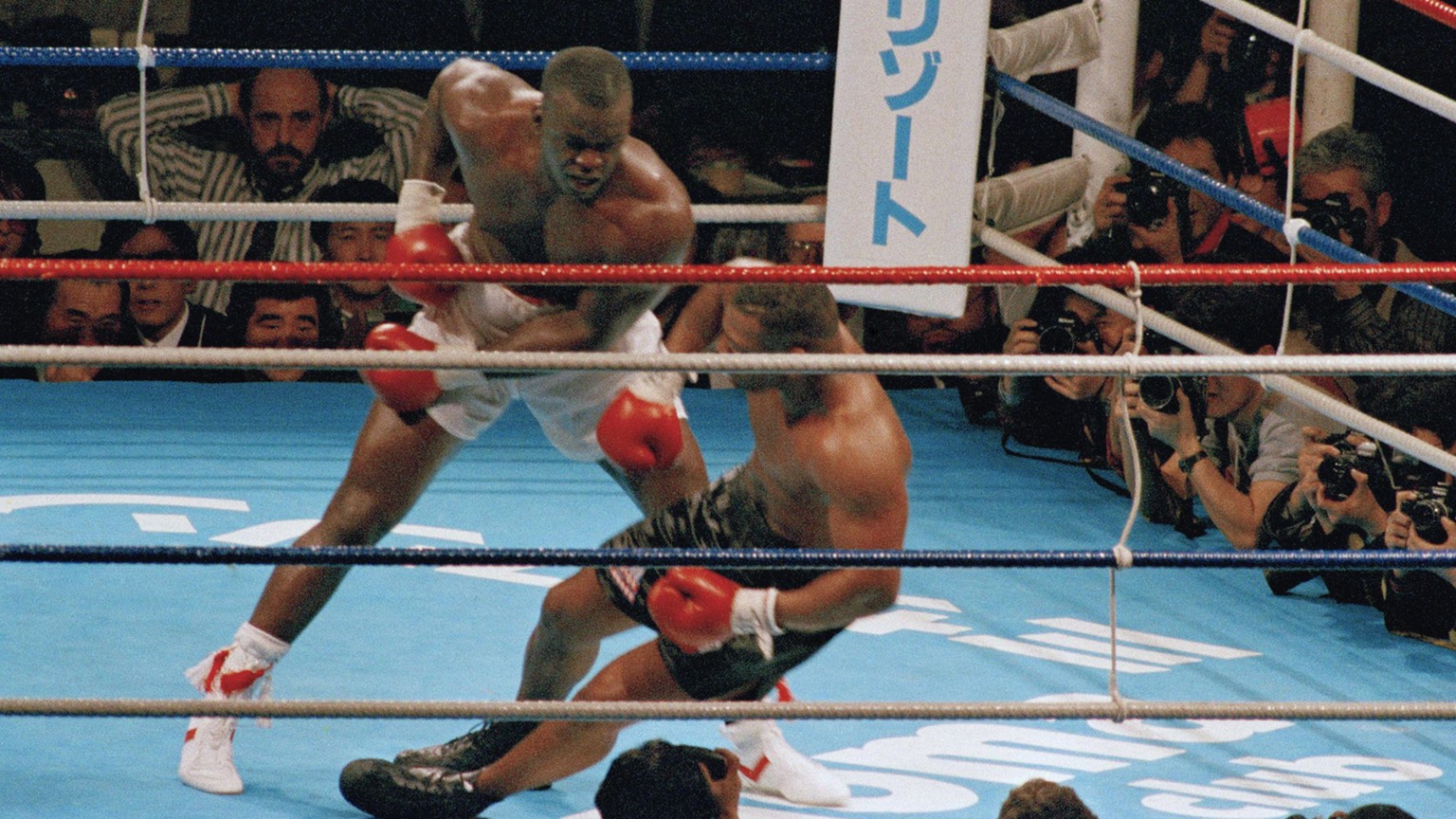 FILE - In this Feb. 11, 1990, file photo, James Douglas follows with a left, dropping Mike Tyson to the canvas in the 10th round of scheduled 12-round heavyweight champion bout at the Tokyo Dome in To ...
