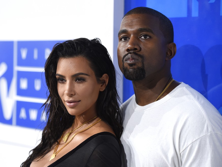 FILE - In this Aug. 28, 2016 file photo, Kim Kardashian West, left, and Kanye West arrive at the MTV Video Music Awards in New York. Kardashian West announced on her app Tuesday, Jan. 16, 2018. the bi ...
