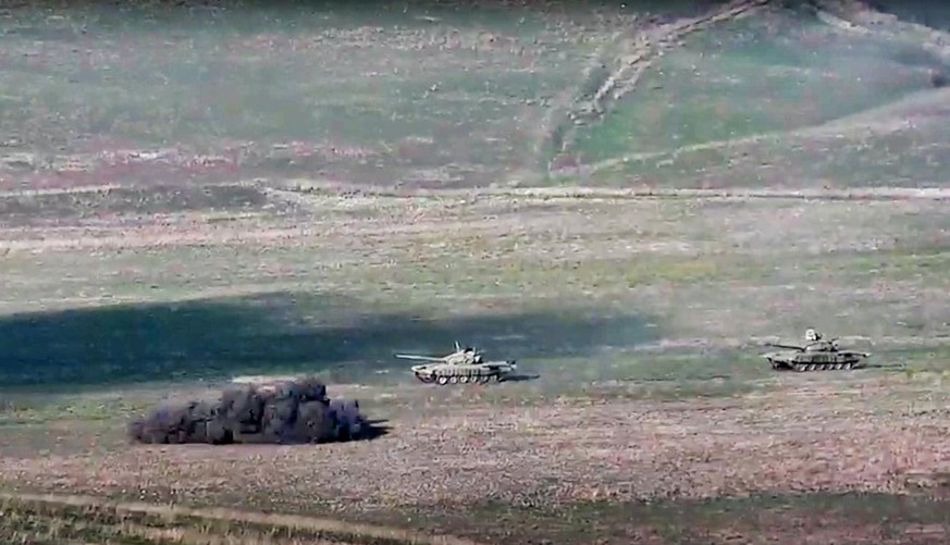 In this image taken from a footage released by Armenian Defense Ministry on Sunday, Sept. 27, 2020, Armenian army destroys Azerbaijani tanks at the contact line of the self-proclaimed Republic of Nago ...