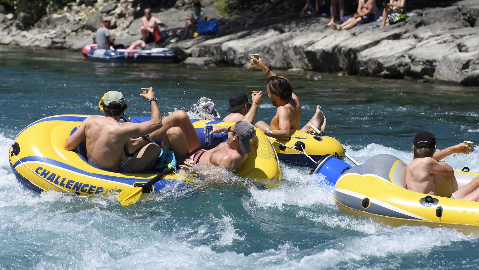 People on inflatable boats enjoy the sun on the Aare River at Uttigen, between Thun and Bern, Switzerland, during the sunny and warm weather, Monday, June 1, 2020. (KEYSTONE/Anthony Anex)