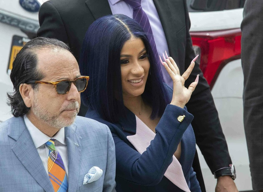 Grammy-winning rapper Cardi B, right, waves at fans as she arrives for a hearing at Queens County Criminal Court, Tuesday, June 25, 2019, in New York. (AP Photo/Mary Altaffer)
Cardi B